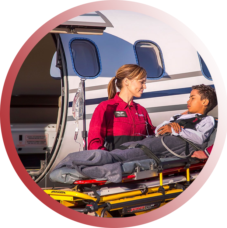 Female Driver with a sleeping child on the medical transport bed